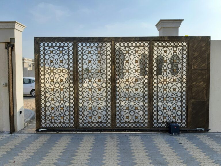 A beautiful patterned gate contrasts the Dubai landscape, capturing modern elegance.